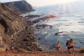 A group walking along the coast at the West Coast Algarve