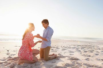 Man proposing to woman on beach