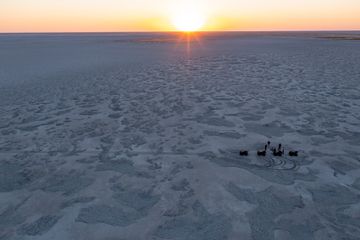 Quad biking across salt flats in Botswana