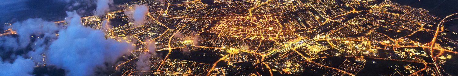 Aerial view from airplane of city lights in the night sky
