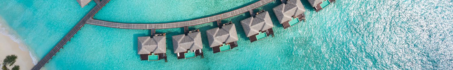 aerial top view overwater villas in lagoon of tropical island