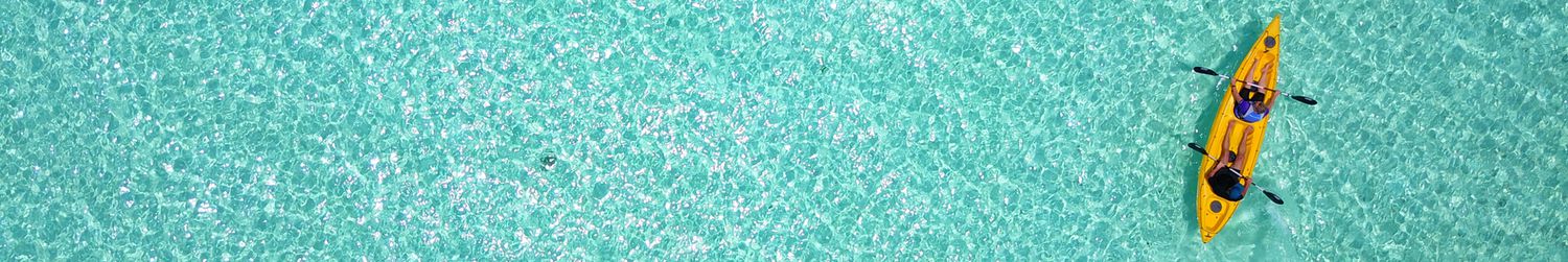 Top view of happy couple kayaking in Maldives ocean, summer concept. Copy space