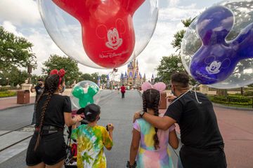 Guests walk down Main Street, U.S.A. at Magic Kingdom Park, July 11, 2020, at Walt Disney World Resort