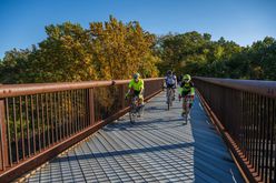 Three cyclists over a bridge on the Empire State Trail