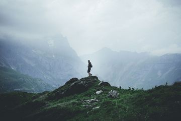 Man hiking on mountain in fog