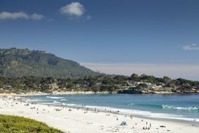 People enjoying the golden sands of Carmel beach on a warm spring day, Carmel, California.