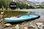An Isle Pioneer Inflatable stand up paddle board floating in a lake