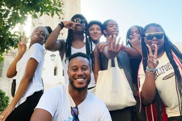 Lamar Shambley with a group of teen study-abroad students