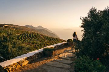 A woman walking into the entrance of the Manalis Winery on the island of Sikinos in Greece