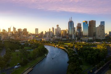 Sunset view of Yarra river and Melbourne skyscrapers business office building with evening skyline in Victoria, Australia. Australia tourism, modern city life, or business finance and economy concept