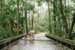 Montage Palmetto Bluff's Naturalist with guests on a bridge in nature