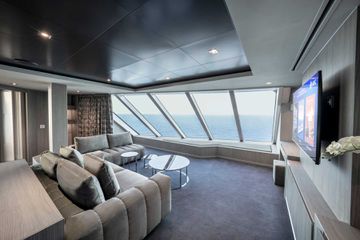 Panoramic windows in the living area of one of MSC Seashore’s Yacht Club Owner’s suites