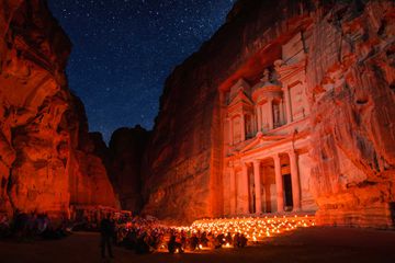 Petra seen at night under the starts with candle light
