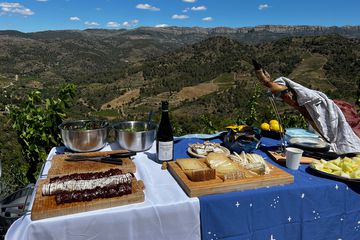 A picnic lunch atop mountains complete with food and wine.
