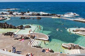 Swimmers and sunbathers at the pools of Porto Moniz, in Madeira, Portugal