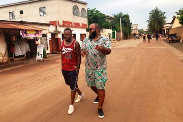Two men exploring the streets of Lomé, Togo