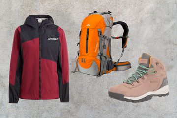 Collage of a waterproof jacket, hiking backpack and hiking boots on a stone background