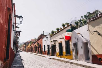Mexican flag flying from a house on a residential street in San Miguel de Allende