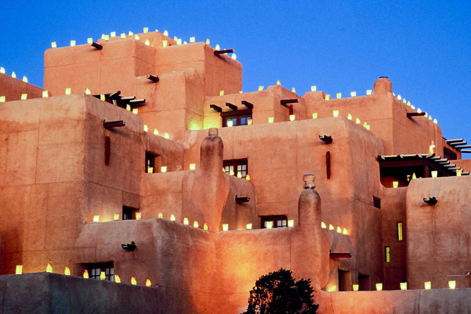 Pueblo-Style Loretto Hotel Christmas Farolito At Dusk