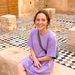 Olivia sitting with mosaic tiles in background