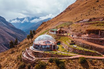 Luxury boutique hotel with clear dome structure nestled in the mountains of Peru. Panoramic views from inside guest room and restaurant