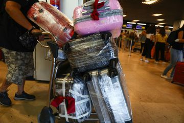 Foil wrapped luggage are seen at the Barajas Airport in Madrid