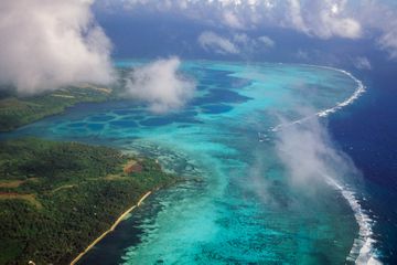 Aerial view of the east coast with coral reef and mangrove edged shoreline, Yap Island, Micronesia.