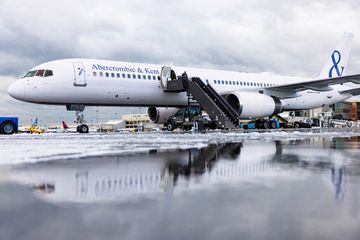 An Abercrombie & Kent private plane at an airport tarmac