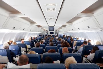 The interior of an airplane with passengers