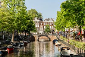 A canal lined with boats on a sunny day