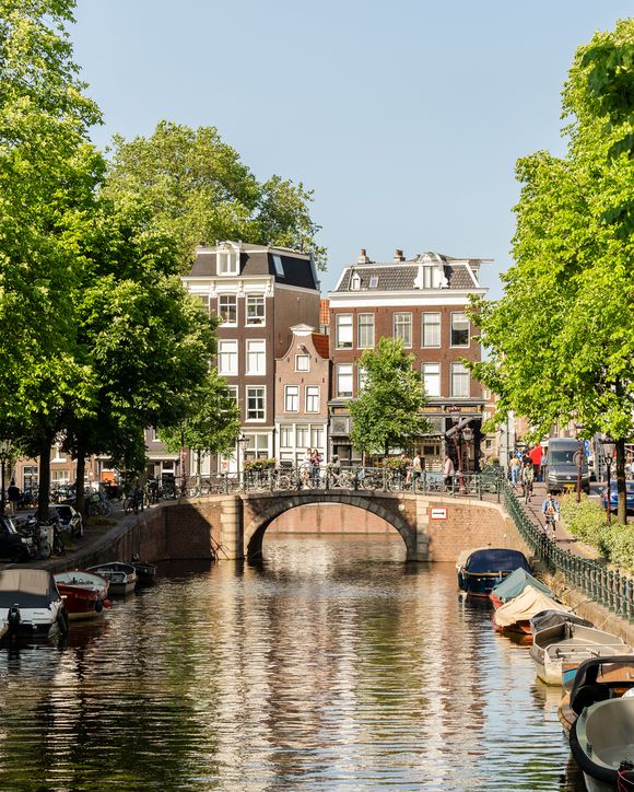 A canal lined with boats on a sunny day
