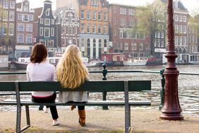 Two woman sitting on a bench in Amsterdam 