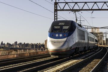 An Amtrak train with New York City and the Bronx behind it 