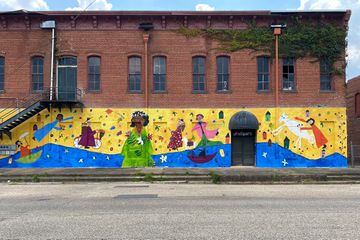 A mural on the side of a building with an antique shop in the Black Belt of Alabama 