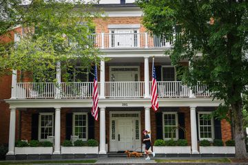 A person runs with their dog in front of The Inns of Aurora in New York state
