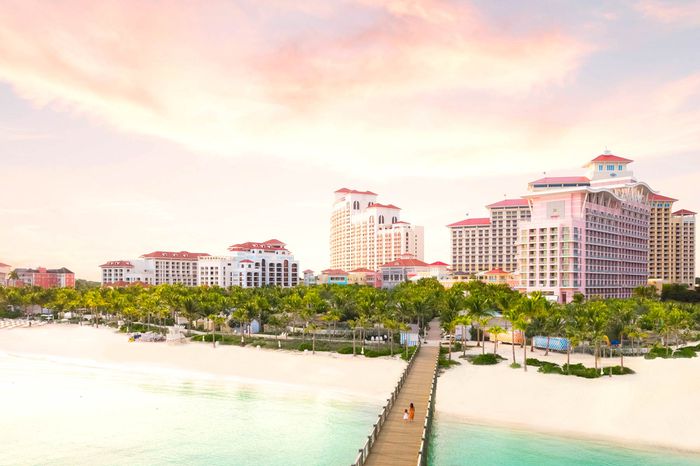 Exterior view of Baha Mar resort in Nassau at sunset with a long boardwalk pier up the beach