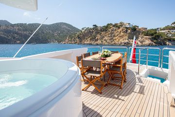 Yahct deck with hot tub and dining table 