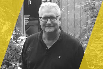 A black and white portrait of a person that is listed as an A List Travel Advisor 