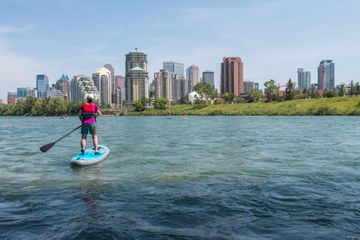  Creative Images Images Creative Editorial Video Creative Editorial Search by image or video Woman stand up paddleboards along river, Calgary city skyline behind