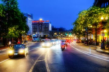 Nighttime street scene with cars and headlights
