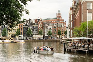 A tourist boat taking a sail through the canals of Amsterdam