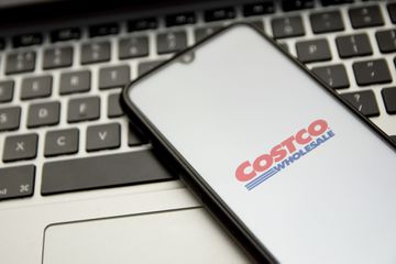 Costco logo seen displayed on a smartphone screen with a computer keyword in the background in Athen