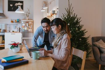 Man and woman on a laptop at home 