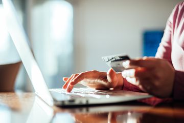 Woman shopping online with a credit card 