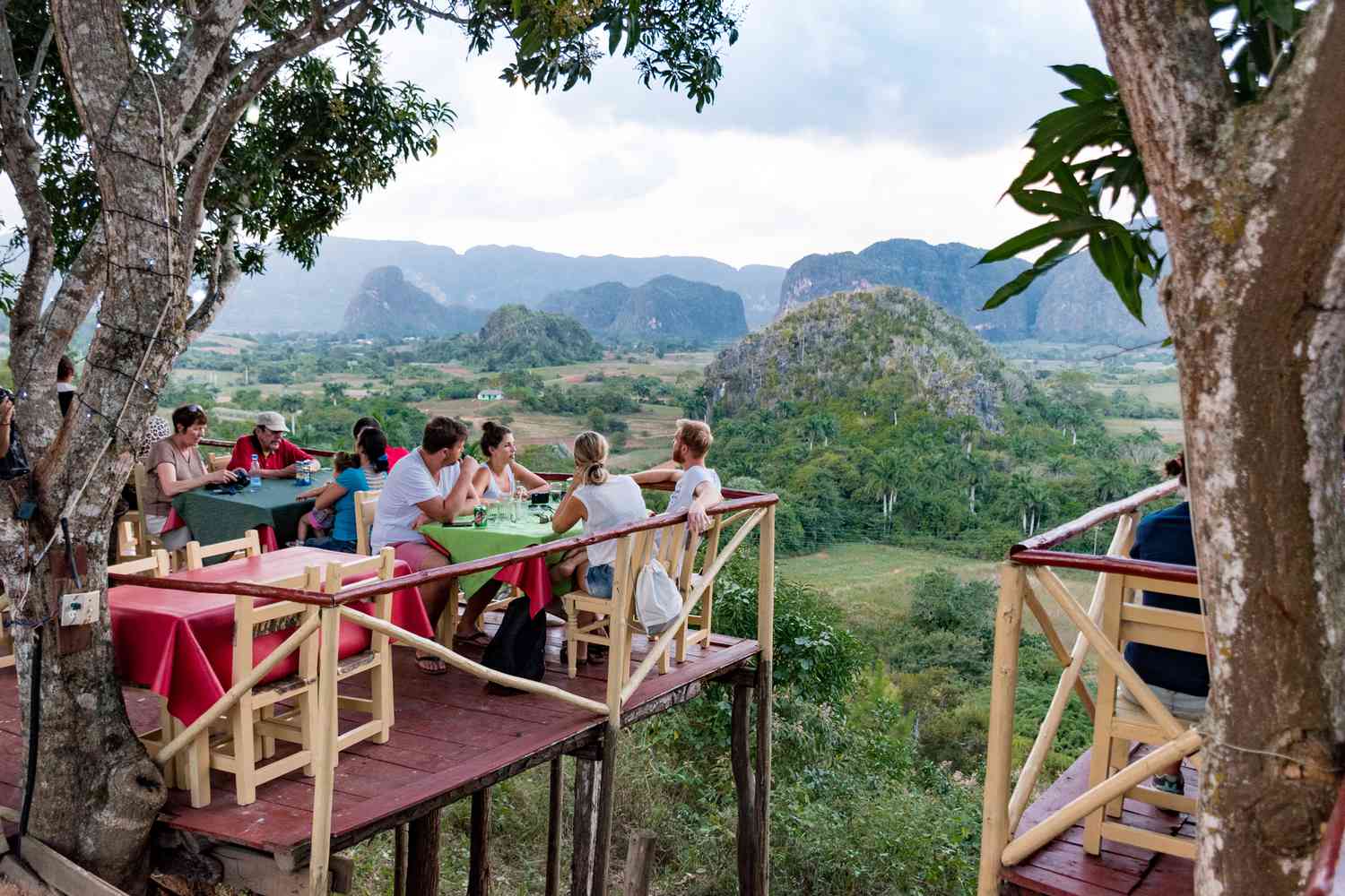 People eating at a restaurant overlooking a valley in Cuba