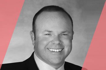 A black and white (grayscale) portrait of a person listed in the text as A List Travel Advisor