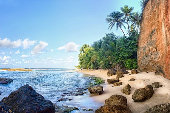 A beautiful secluded white sand beach on Atlantic side of Dominica, Eastern Caribbean.