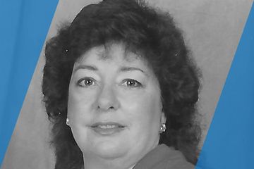 Black and white portrait of a person who is listed as an A List Travel Advisor 