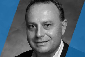 Black and white portrait of a person who is listed as an A List Travel Advisor 