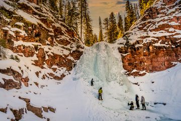 A group of people ice climbing at Dunton Hot Springs resort in Colorado